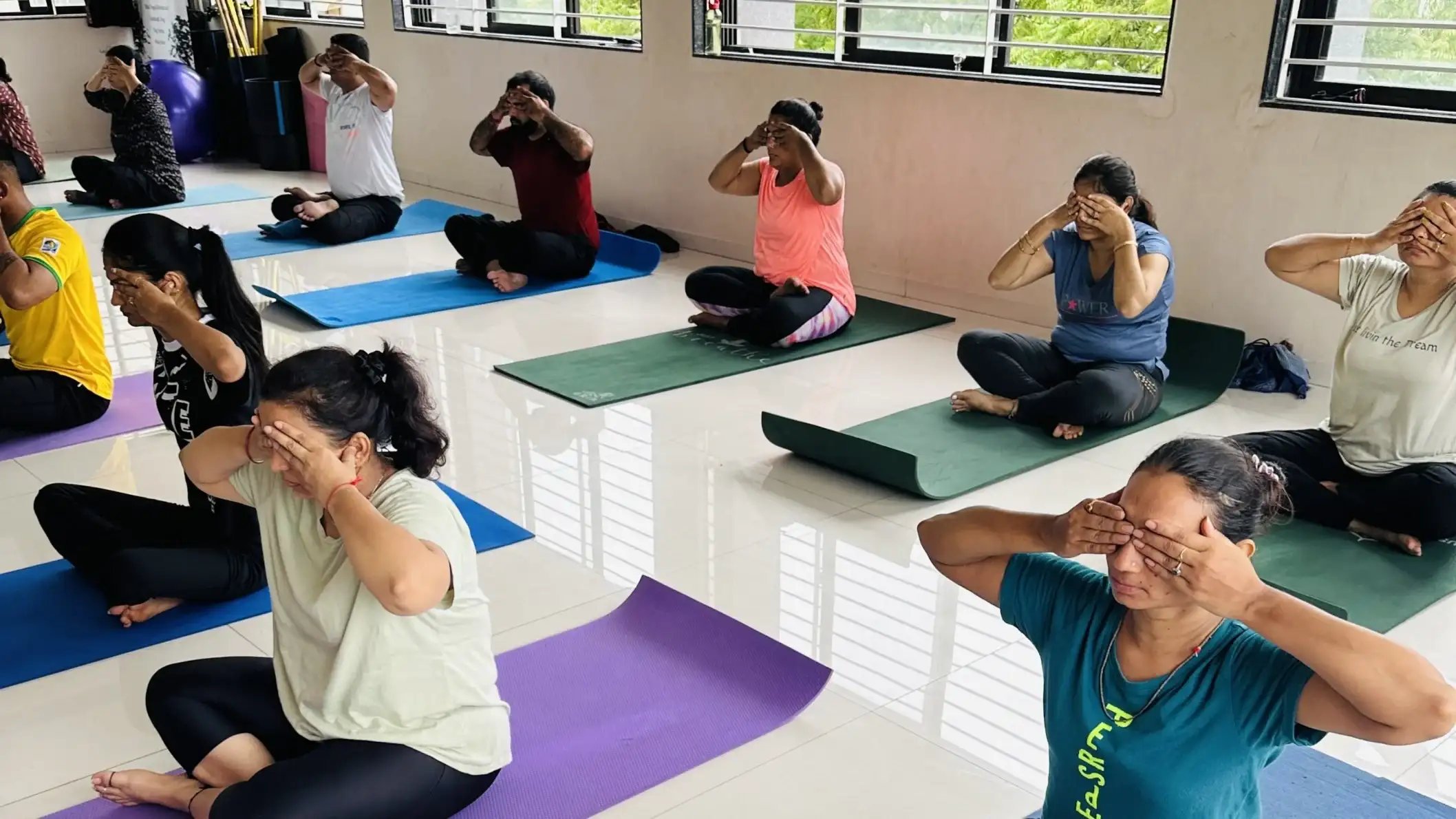 An evening batch in Ahmedabad practicing deep mindfulness and stress relief techniques.