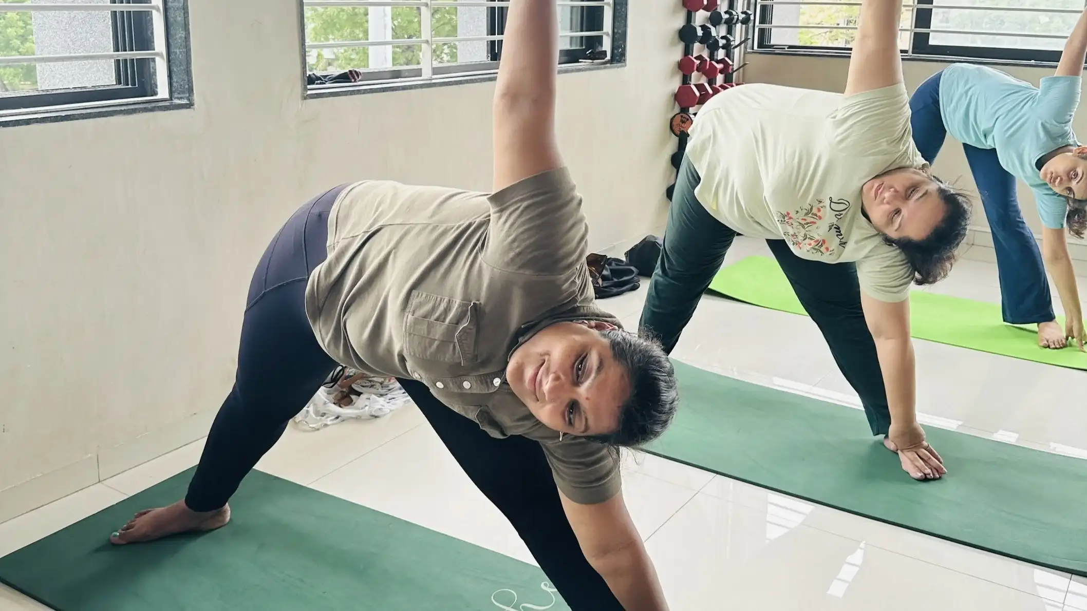 Focused execution of the Triangle pose during a strength and weight loss session.
