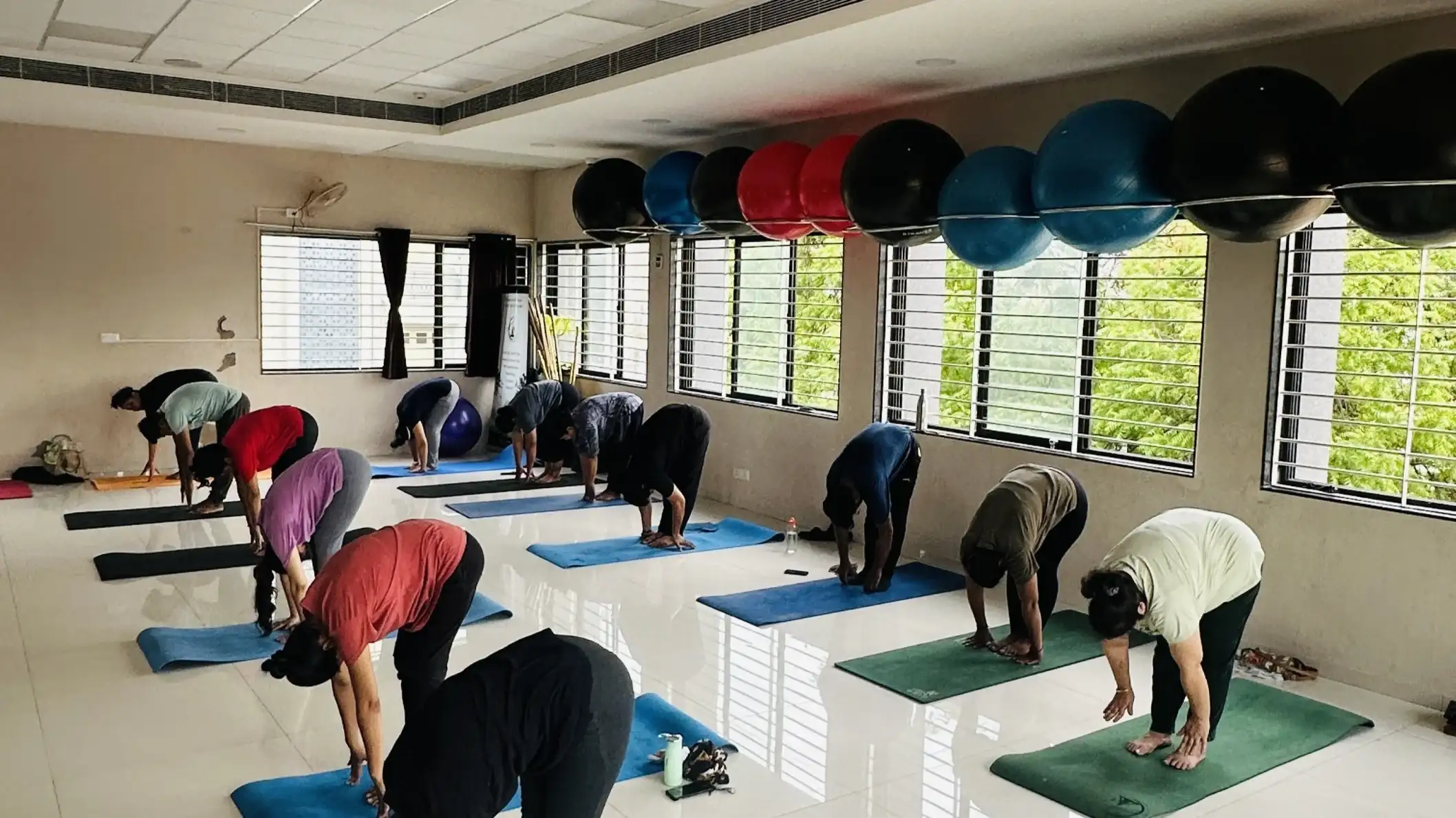Early morning practitioners performing synchronized yoga sequences for an energy reset.