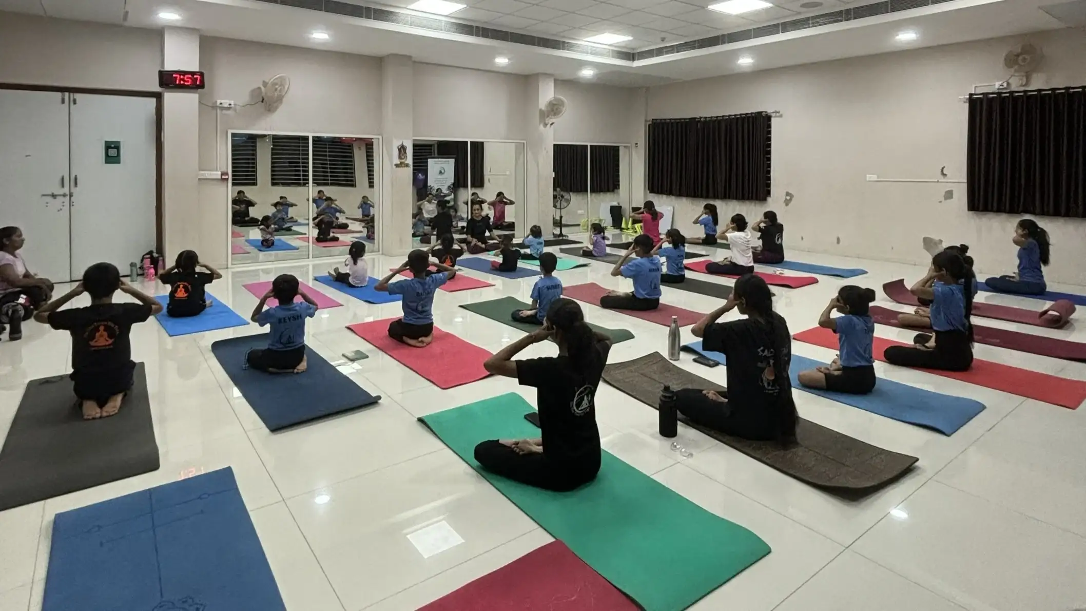 A peaceful session of beginner students practicing seated meditation and breathwork.