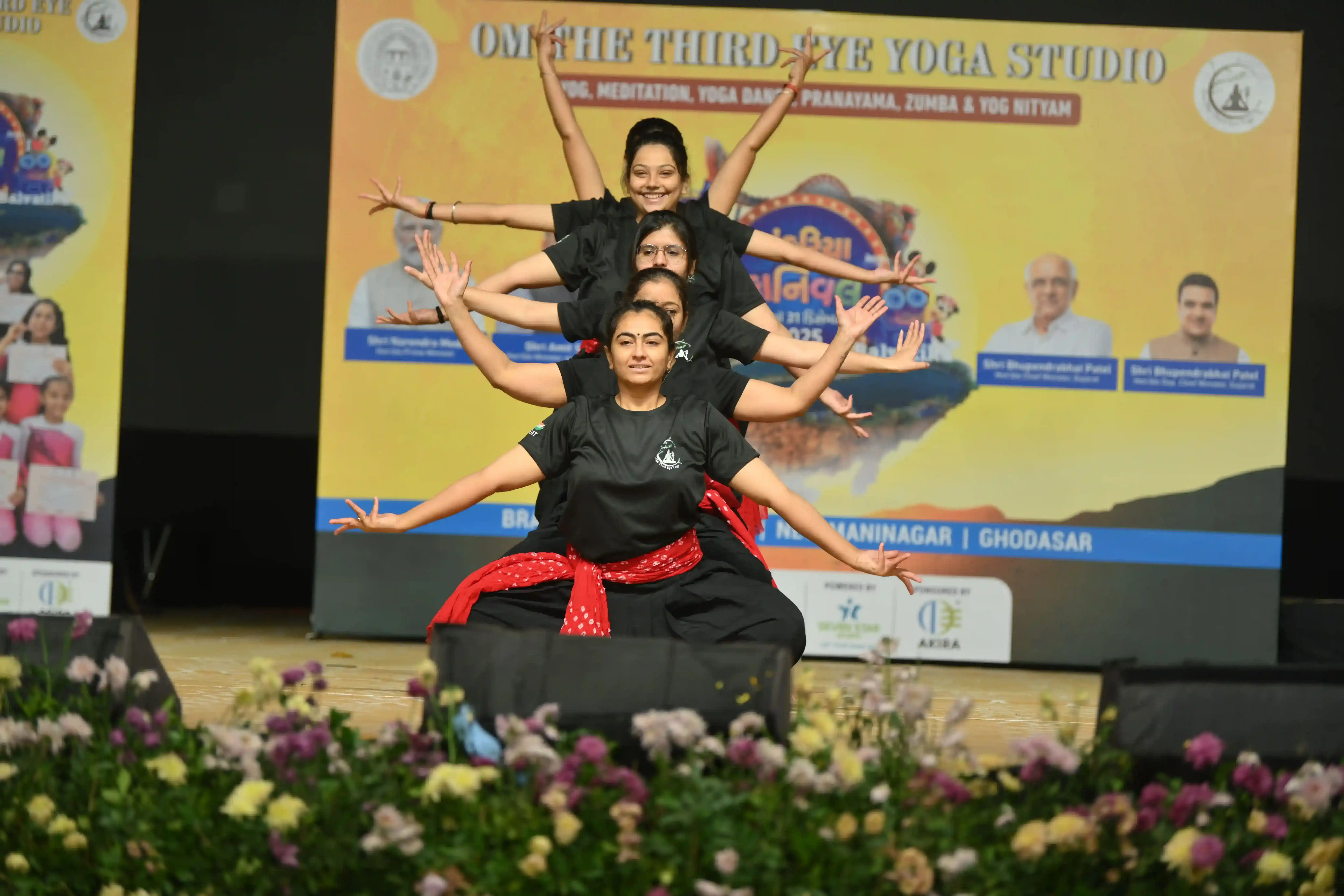 Students utilizing suspended fabrics for a unique aerial yoga workout.