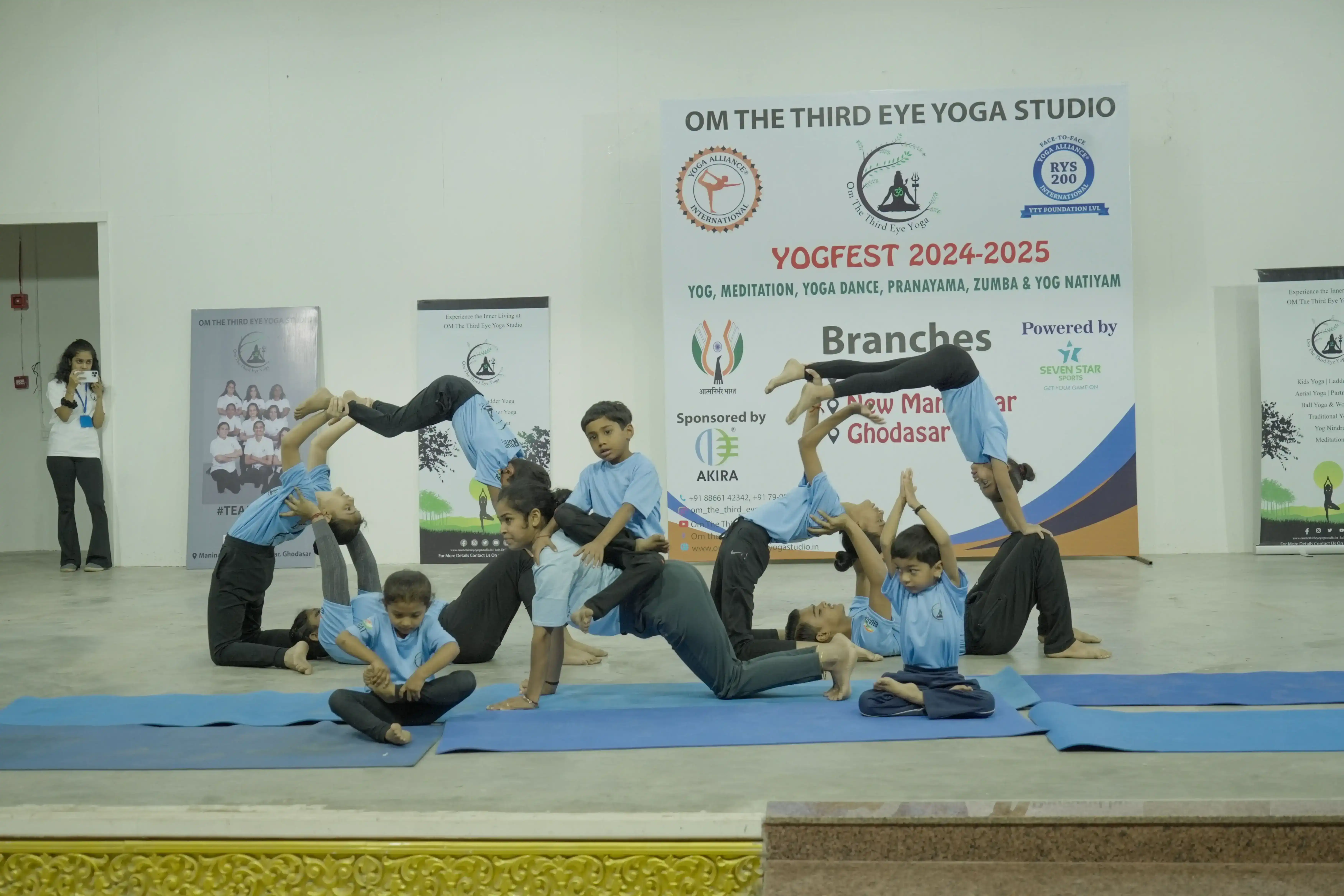 Young students performing a creative and complex acrobatic yoga formation in Ahmedabad.