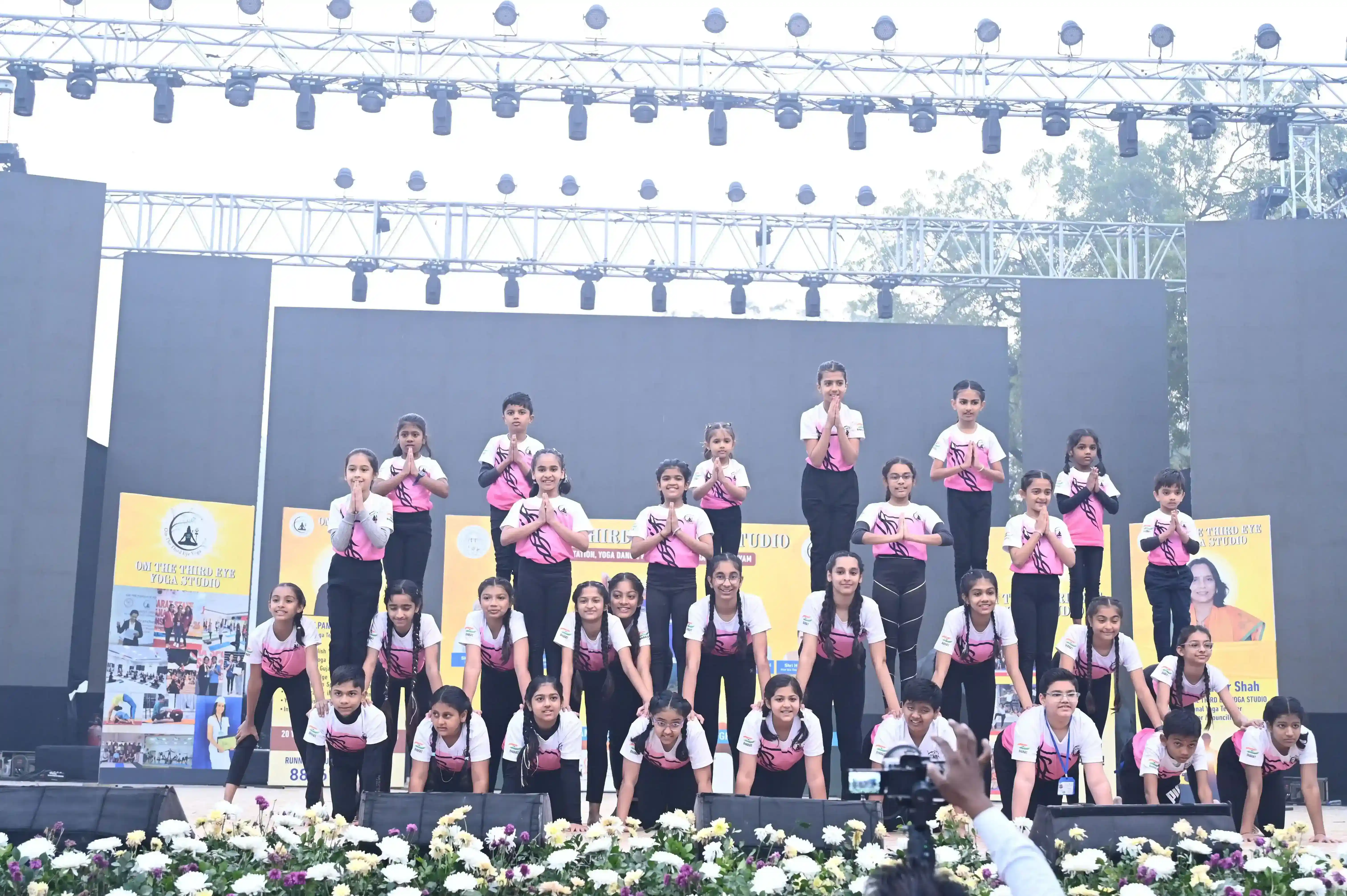 Young practitioners demonstrating teamwork and balance in a group yoga formation.