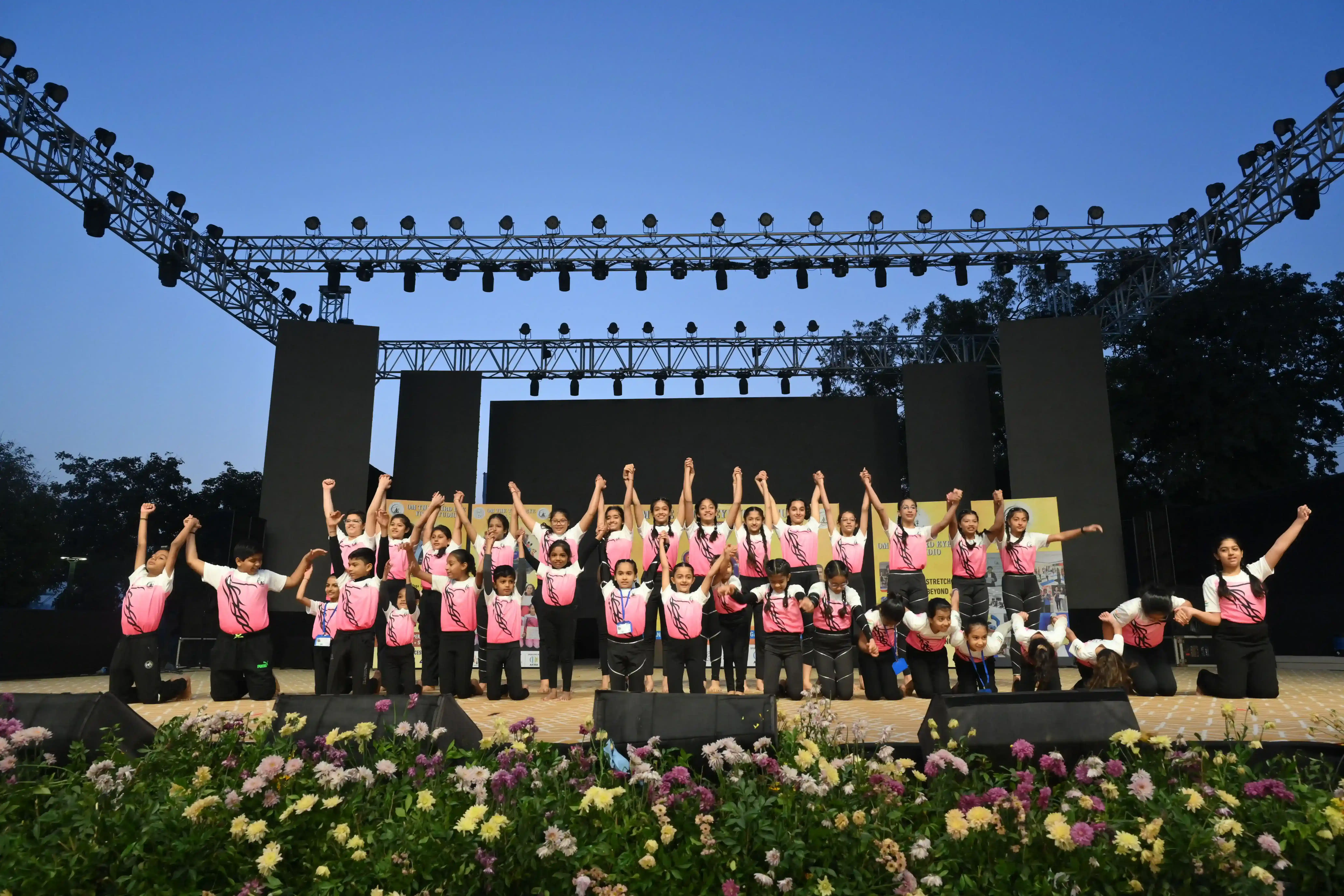 A large gathering of youth students celebrating a yoga milestone in Ahmedabad.